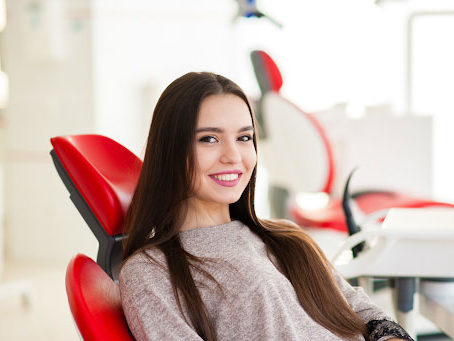 girl in red chair smiling